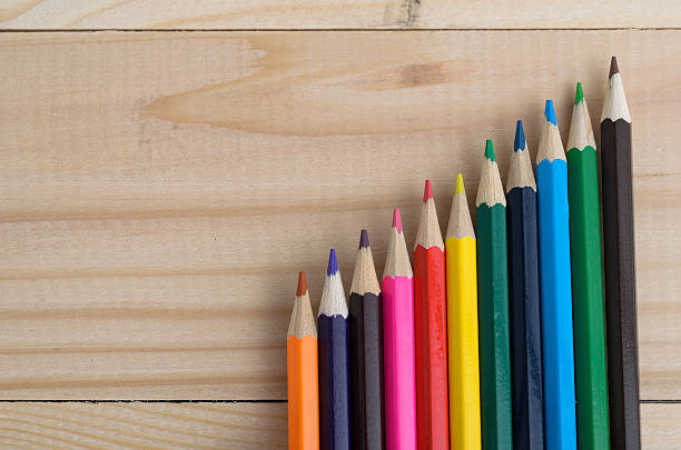 istock Colored pencils on a wooden board 613748112