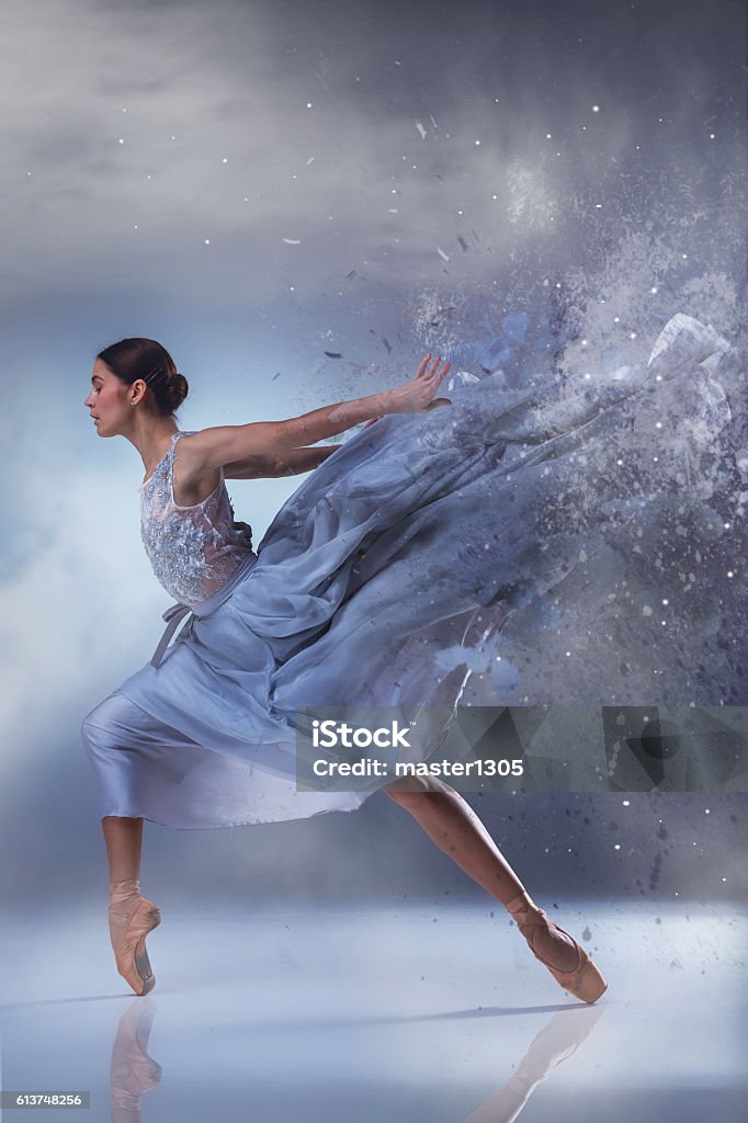 The beautiful ballerina dancing in blue long dress The beautiful ballerina dancing in long lilac dress on lilac background Ballet Dancer Stock Photo