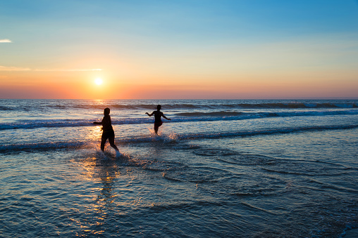 Silhouettes of people enjoying the sunset on the atlantic ocean, Lacanau France