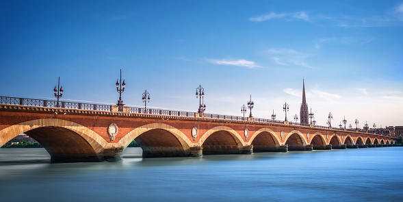 Pont de Pierre bridge with St Michel cathedral, Bordeaux, France