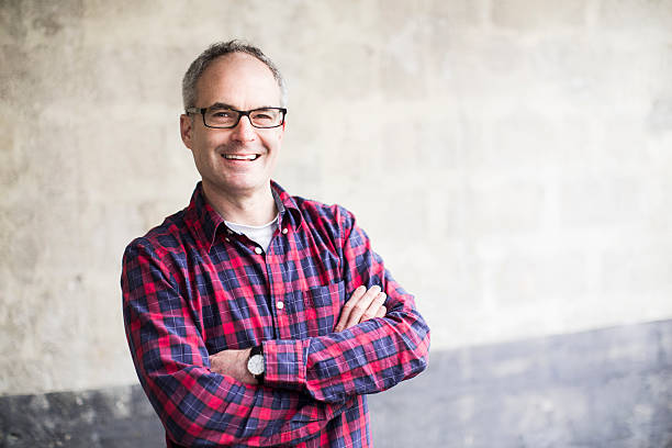 Middle aged man smiling and looking at camera.