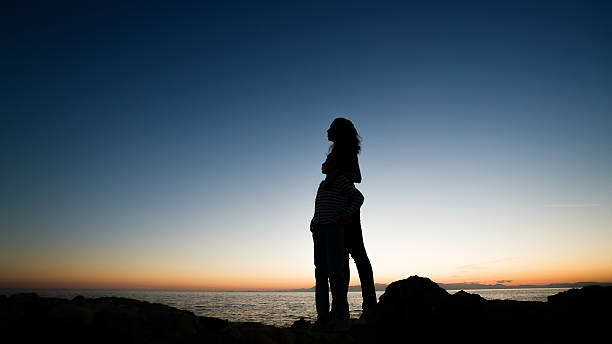 istock mother and son  on the beach sunset 613750844