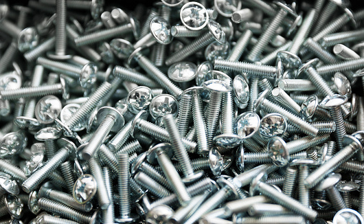 Heap of short metal bolts