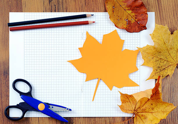 istock tinker with leaves paper and pencil 613752582