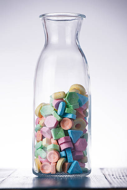 istock Colorful sweet candy in a wine carafe. 613753236