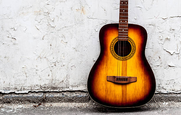 istock classical guitar of wood near a white wall 613754638