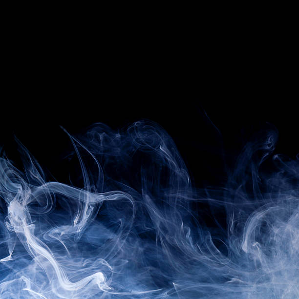 istock blue smoke swirls over black background 613757526