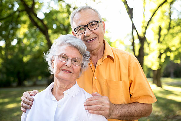 istock Happy senior couple in park 613757554