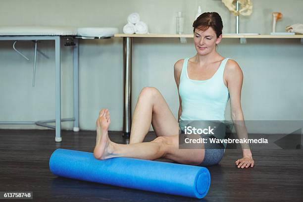 Woman Performing Exercise Using Foam Roll Stock Photo - Download Image Now - Activity, Adult, Alternative Therapy