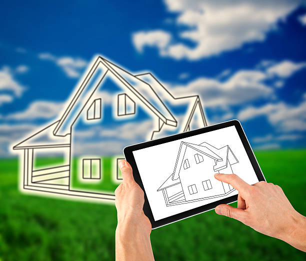 istock man drawing a plan of his house on the tablet 613758804