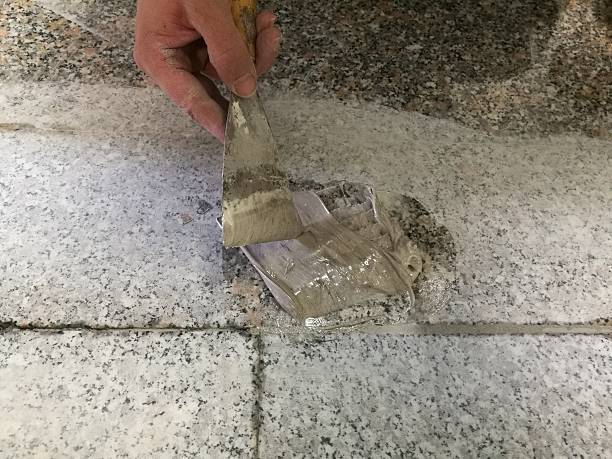 istock Mason repairing the marble floor 613759976