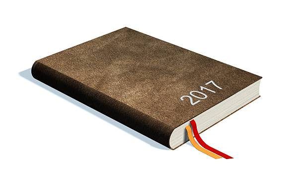 istock Brown calendar books notebooks year 2017 isolated on white 613760256