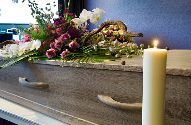 Coffin in morgue A coffin with flower arrangement in a morgue coffin crematorium stock pictures, royalty-free photos & images