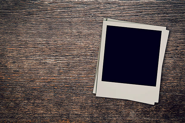 istock Vintage blank photo frame on wood background with space 613762884