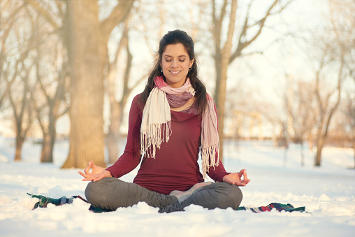 Serene lady relaxing and meditating doing yoga poses
