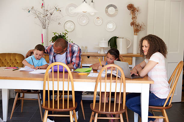 istock Parents Helping Children With Homework At Table 613765032