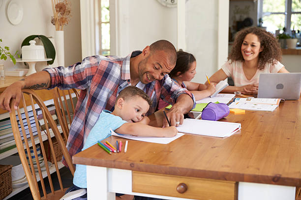 istock Parents Helping Children With Homework At Table 613765034