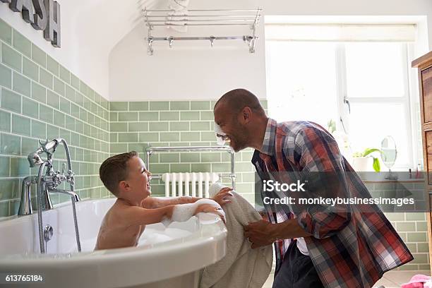 Father And Son Having Fun At Bath Time Together Stock Photo - Download Image Now - Bathtub, Child, Family