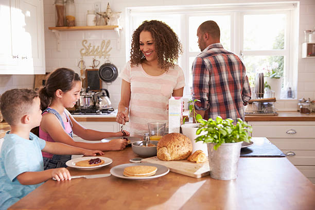 istock Family At Home Eating Breakfast In Kitchen Together 613765296