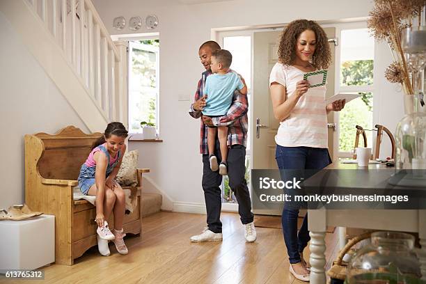 Family In Hallway Returning Home Together Stock Photo - Download Image Now - Mail, Reading, Family