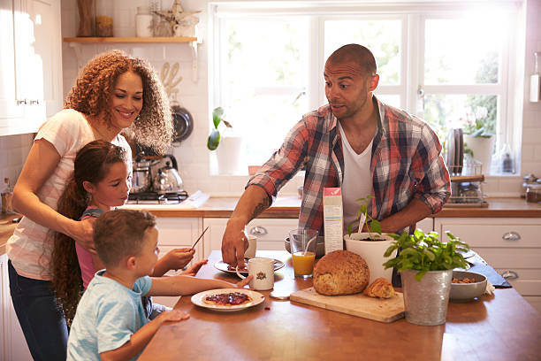 istock Family At Home Eating Breakfast In Kitchen Together 613765346