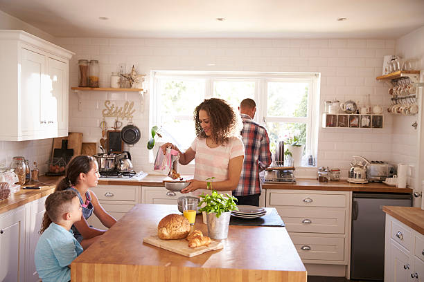 istock Family At Home Eating Breakfast In Kitchen Together 613765384