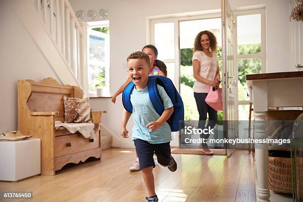 Excited Children Returning Home From School With Mother Stock Photo - Download Image Now