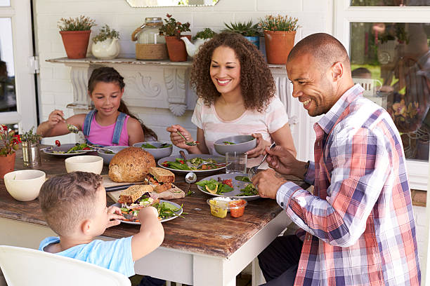 Family At Home Eating Outdoor Meal Together Family At Home Eating Outdoor Meal Together english cuisine stock pictures, royalty-free photos & images