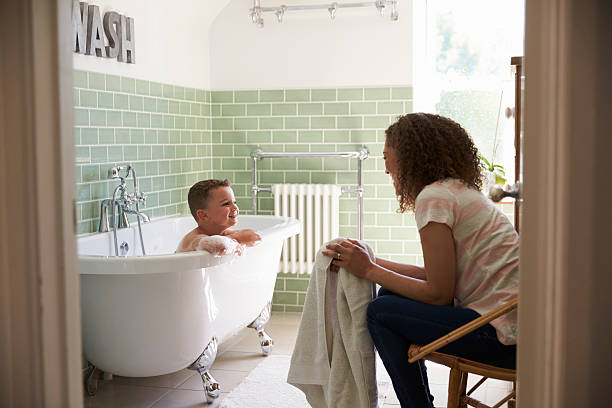 istock Mother And Son Having Fun At Bath Time Together 613765556