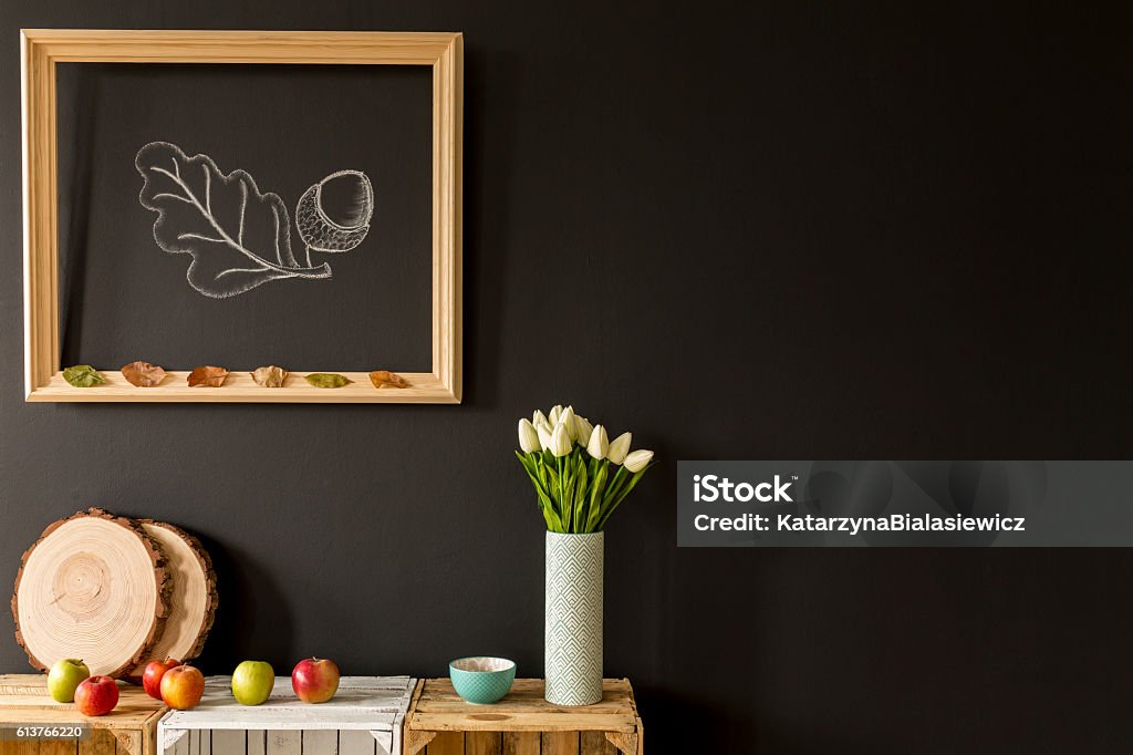Organic home decor for autumn Wooden frame hanging on a black wall and wooden DIY furniture Modern Stock Photo