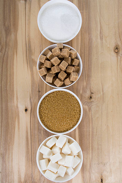 istock Cane and white sugar in a white bowls 613767244