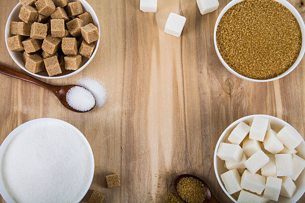 istock Cane and white sugar in a white bowls 613767414