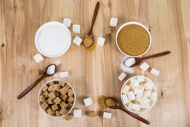 istock Cane and white sugar in a white bowls 613767512