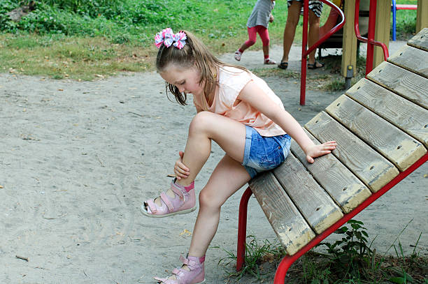 istock Small girl looks at her bruise 613767552