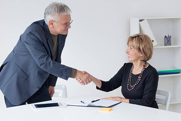istock Two business people shaking hands 613767682
