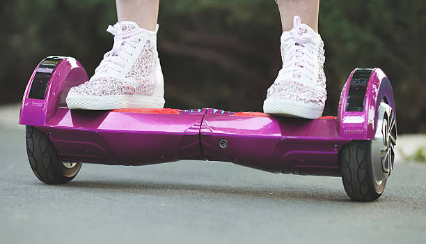 istock woman feet on hoveboard 613767778