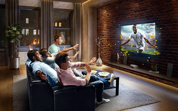 istock Students watching very realistic Soccer game on TV 613768056