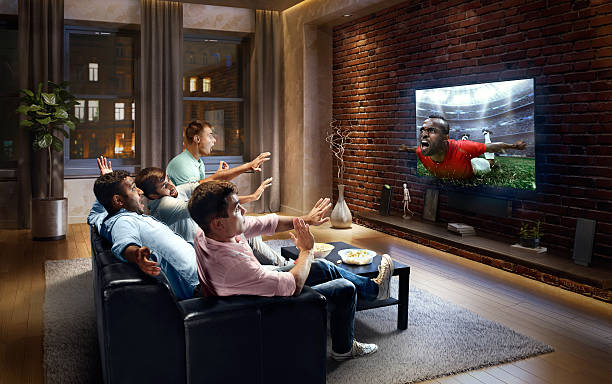 istock Students watching very realistic Soccer game on TV 613768284