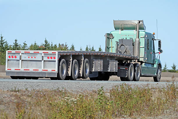 istock Semi Flatbed Trailer Truck,No Load, Travelling On Interstate Highway 613769316