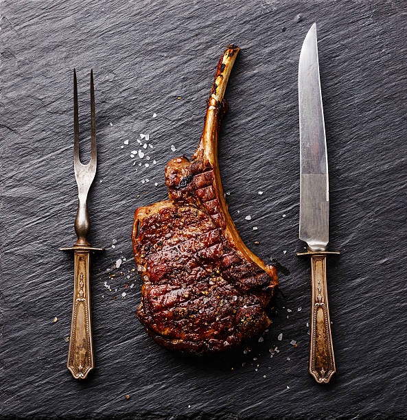 istock Roasted beef Rib with knife and fork 613769642