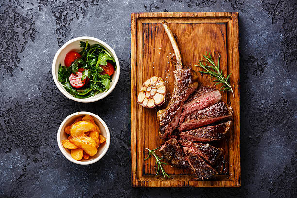 istock Sliced Veal rib with potato and salad 613769658
