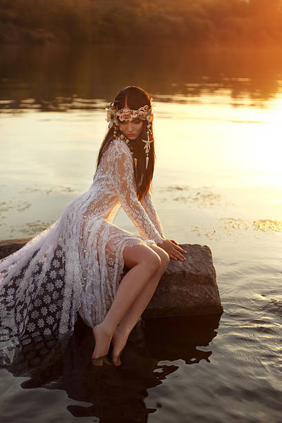 istock Charming brunette looking at the inviting depths of dark water 613769924