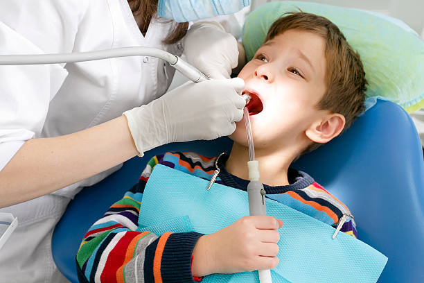 istock Boy and dentist during a dental procedure 613770126