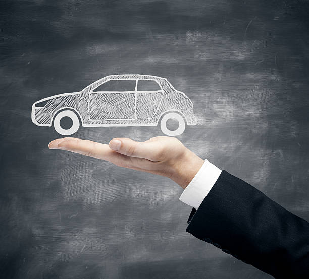 istock Businessman holding car sketch 613770222