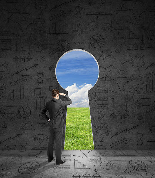 istock Businessperson looking through keyhole 613770764
