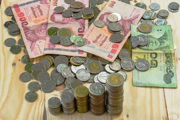 istock Thailand bank notes and coins 613772038