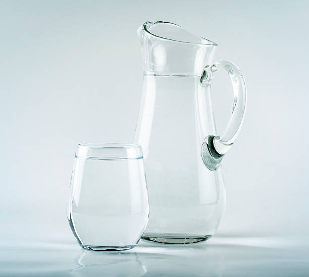 istock Jug and glass on white background 613772286