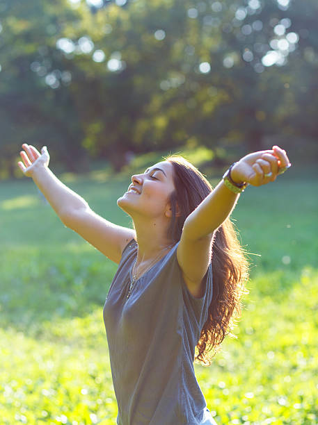istock Beautiful brunette woman expressing freedom in park. 613772452