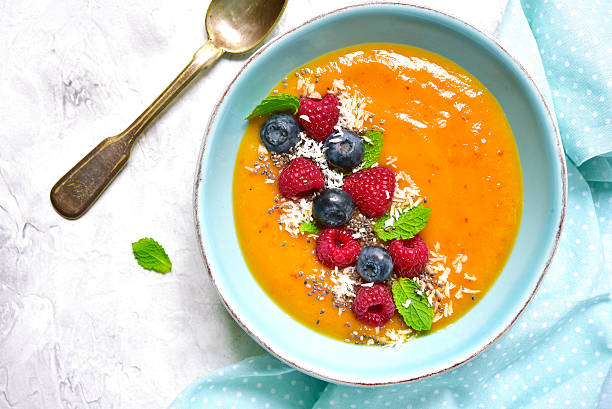 istock Peach smoothie  bowl on a light background.Top view. 613772590