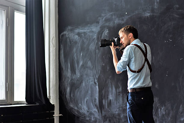 istock photographer working in photostudio with camera in hands 613772976